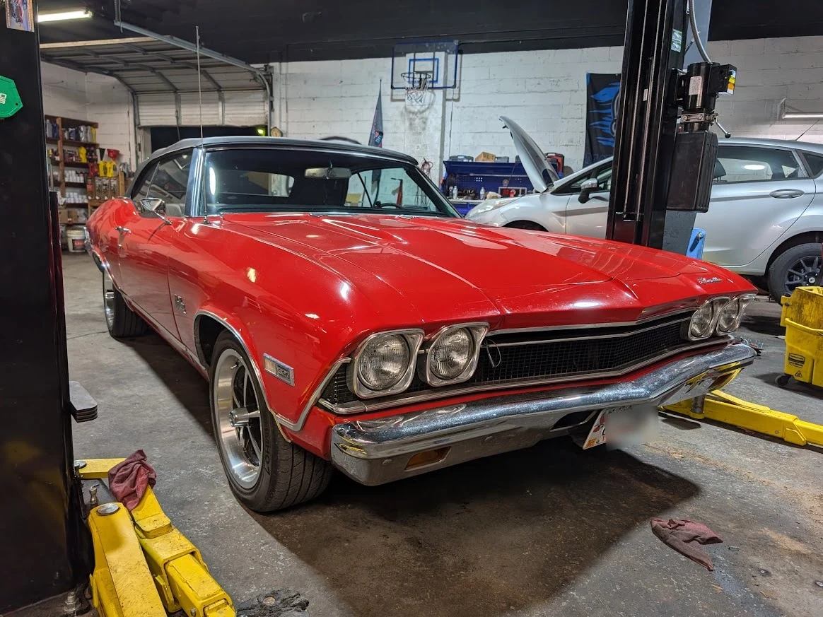Red classic Chevrolet Chevelle inside The Engine Block shop